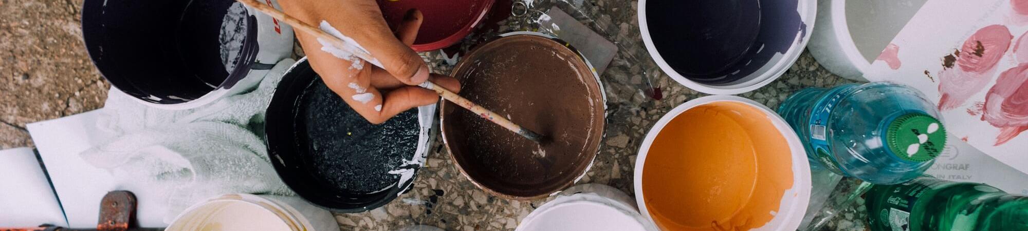 Different buckets with paint by russn_fckr on Unsplash.