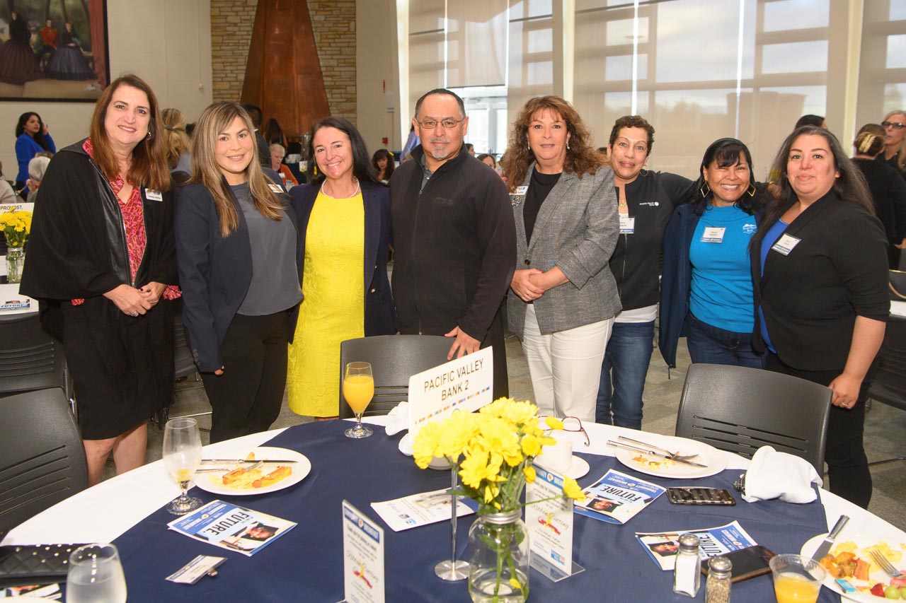 Group of attendees behind table