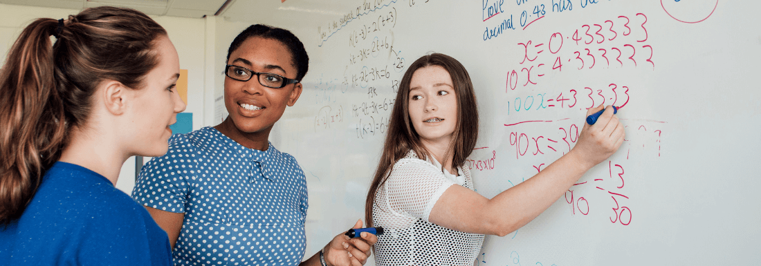 Students writing on whiteboard