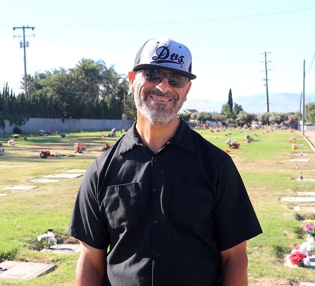 Person working in cemetery smiling