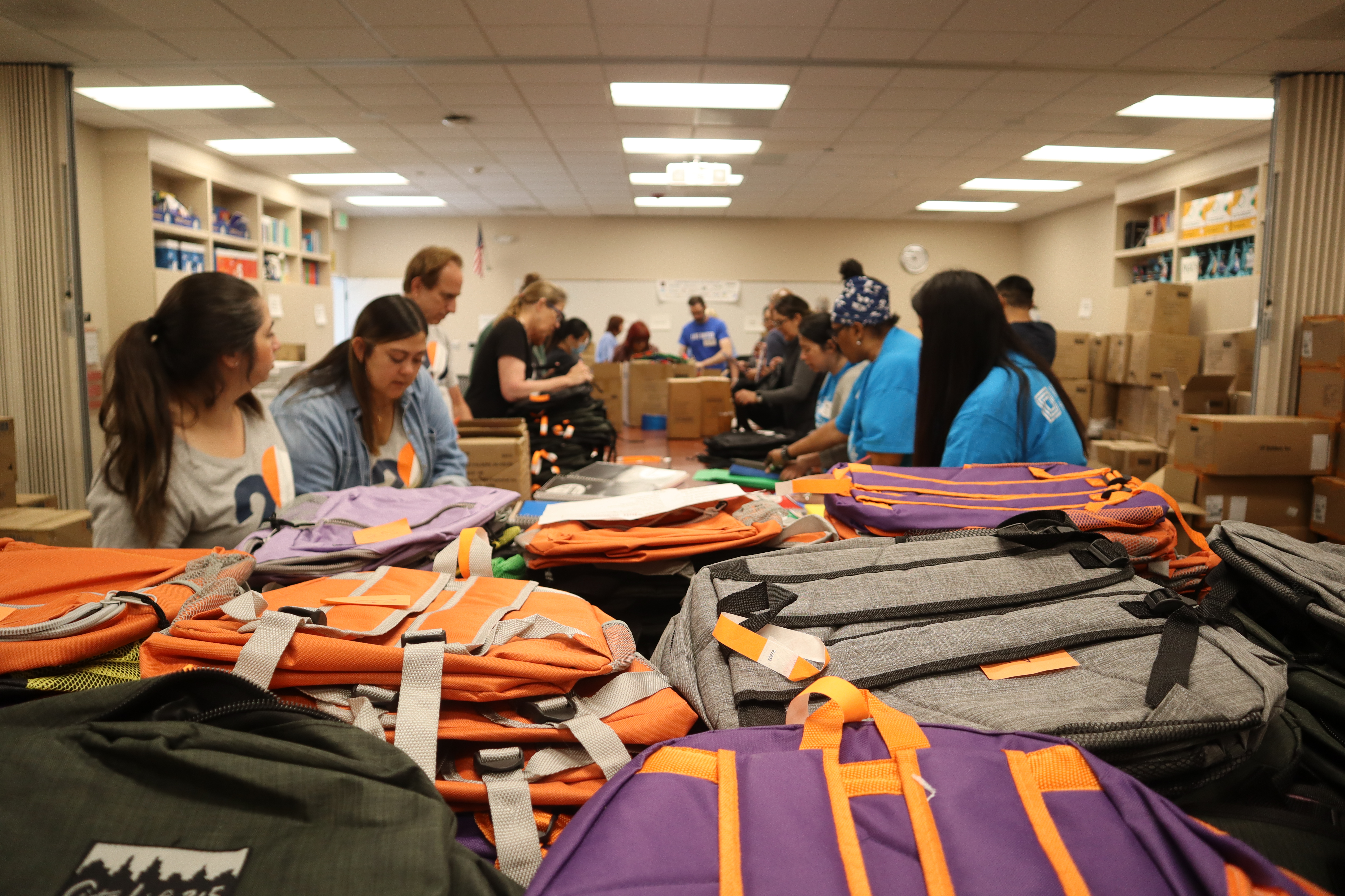 Volunteers putting supplies in backpacks