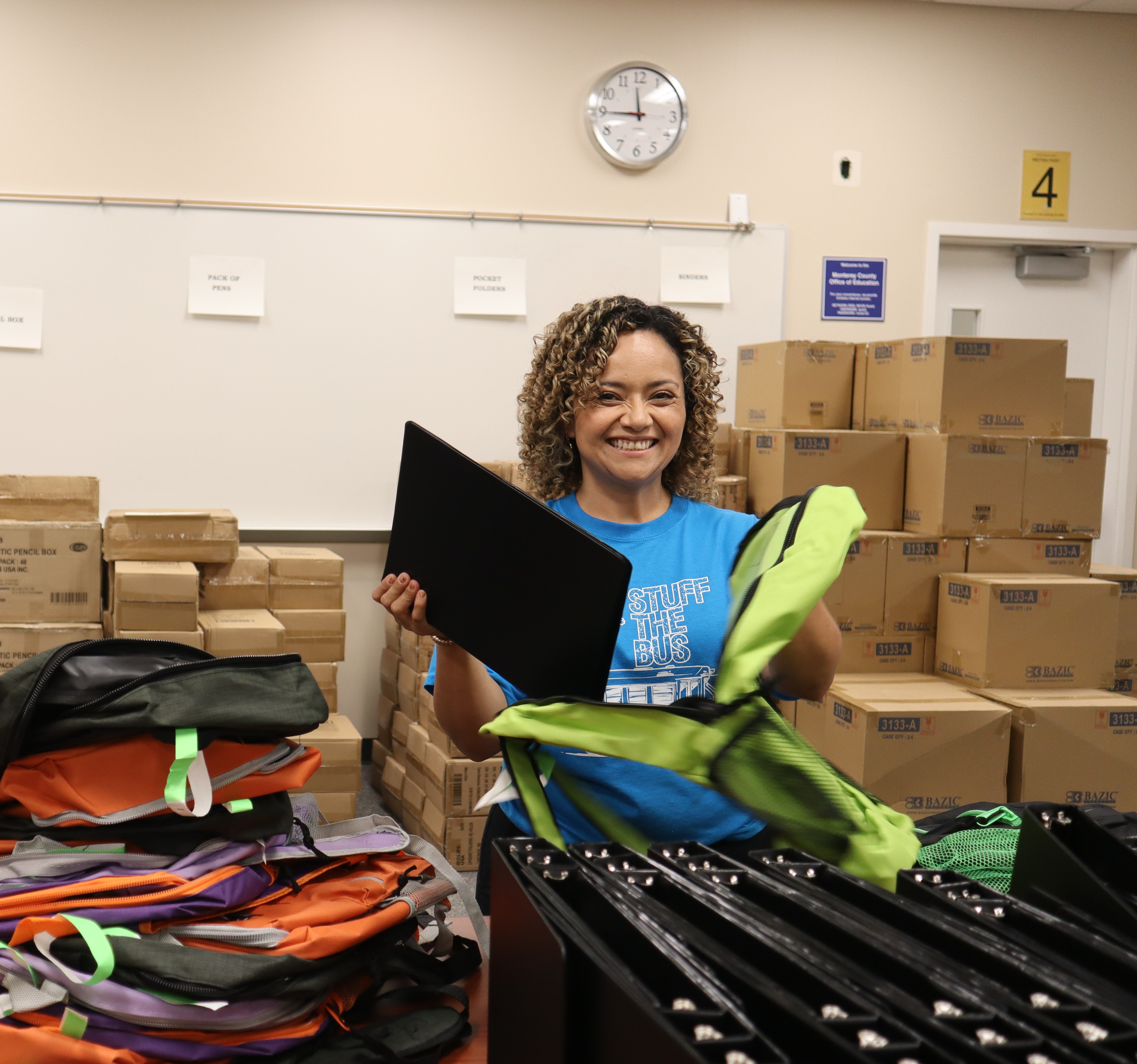 Volunteer stuffing a backpack