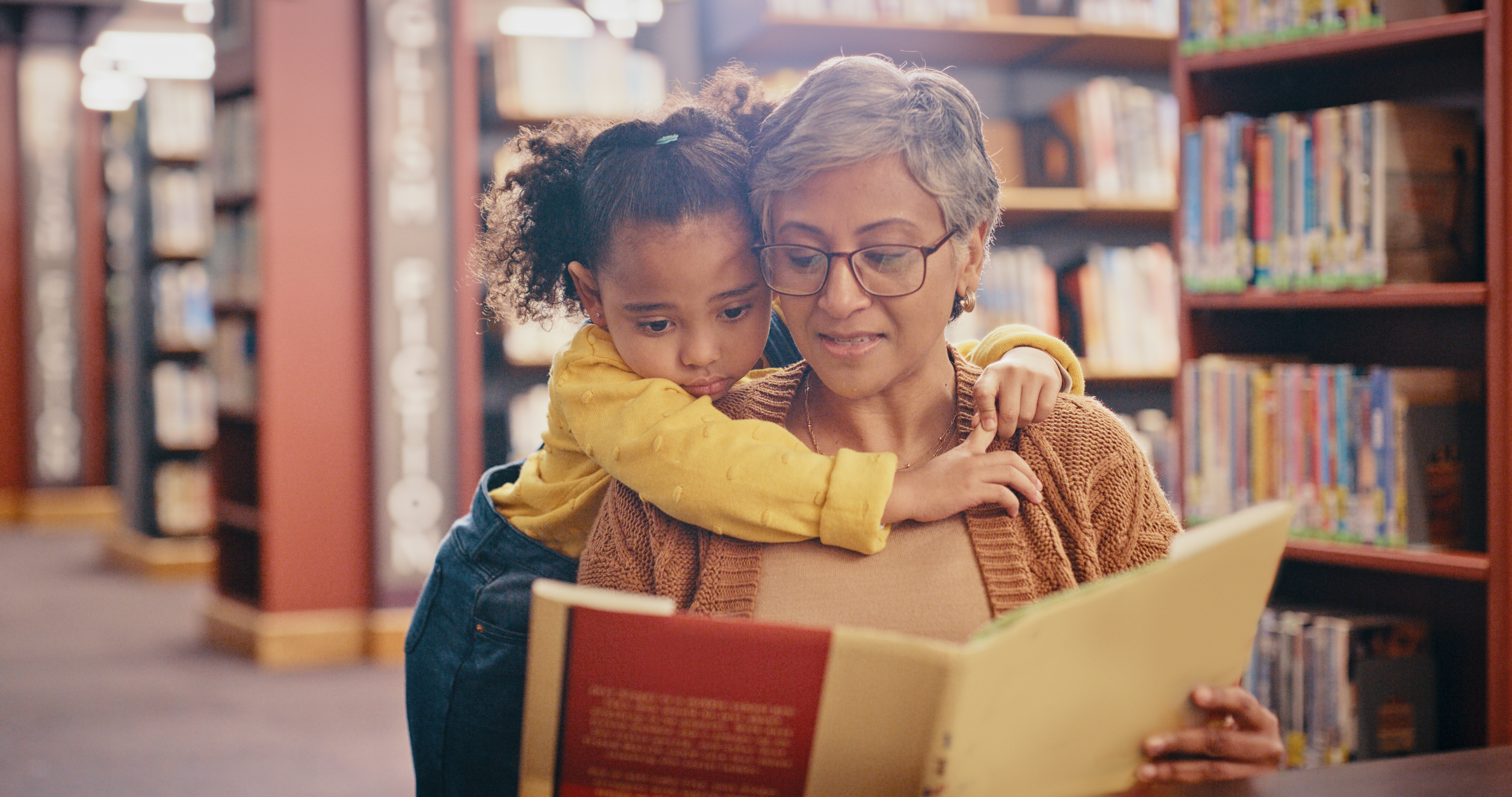 Grandmother reading book to child