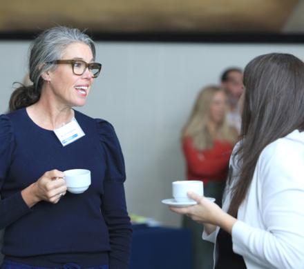 Two Community Breakfast attendees talking