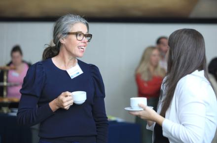 Two Community Breakfast attendees talking