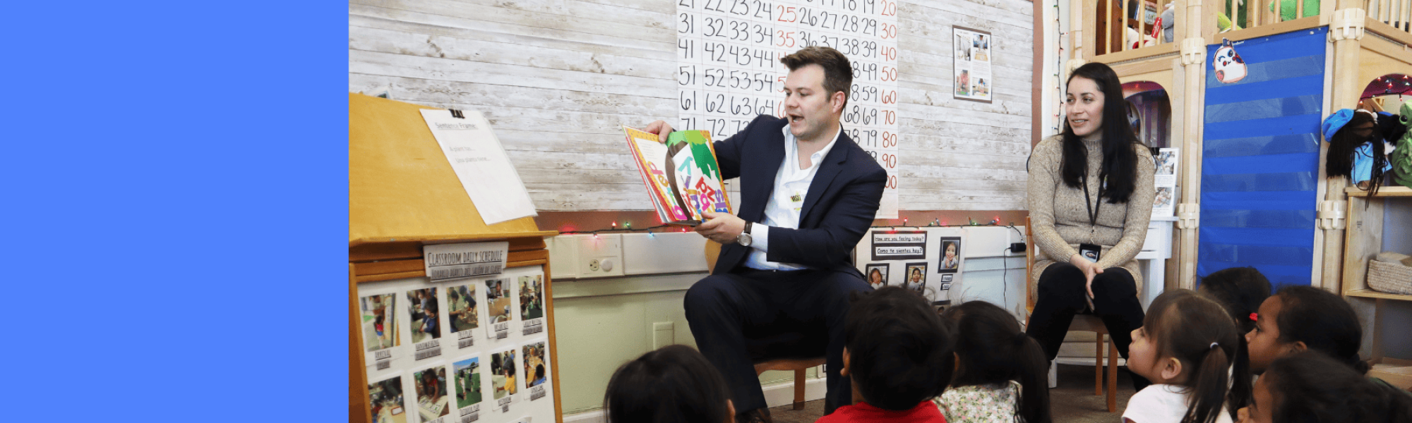 Two ELS members reading to a classroom