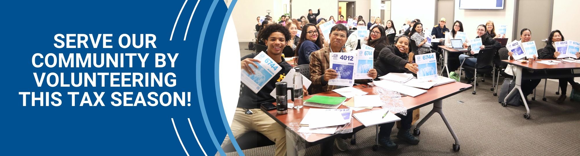 Serve our community by volunteering this tax season! VITA volunteers holding up booklets