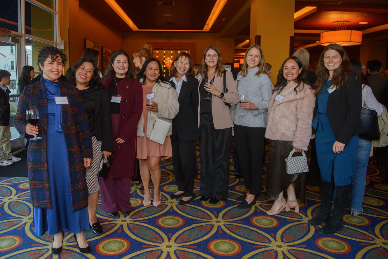 Group of women, some holding wine glasses